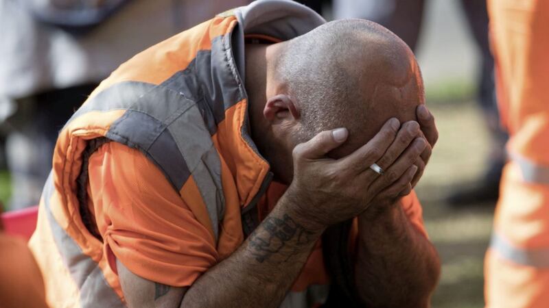 A bin worker puts head in his hands in Birmingham after refuge collectors went back on strike following a council decision to begin issuing redundancy notices PICTURE: Aaron Chown/PA 
