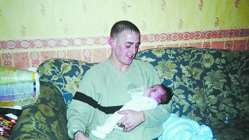 Gerard Lawlor, pictured holding his baby son, was shot dead by the UFF in north Belfast on July 22 2002, 20 minutes after the group wounded Jason O’Halloran nearby
