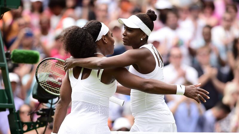 Sisters Serena (left) and Venus Williams embrace after their clash at Wimbledon on Monday<br />Picture: PA