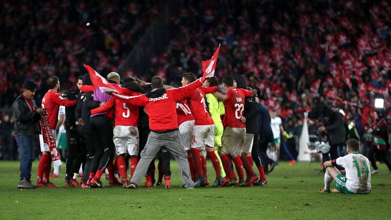 <span style="font-family: Verdana, Arial, Helvetica, sans-serif; font-size: 13.3333px;">Northern Ireland's Stuart Dallas (right) sits dejected as Switzerland players celebrate after the FIFA World Cup Qualifying second leg match at St Jakob Park, Basel</span>&nbsp;