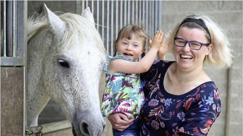 Maisie Colhoun (5) and her mum Dawn get ready for a ride-out on Smokey the pony as part of a special therapy project in Co Derry. Picture By Hugh Russell. 