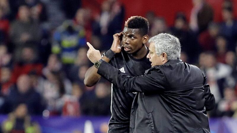 Manchester United manager Jose Mourinho, right, talks to Paul Pogba at the Ramon Sanchez Pizjuan stadium in Seville 