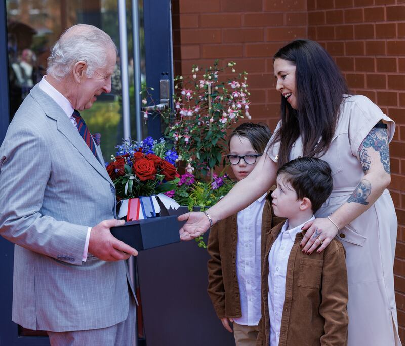 Charles receives gifts of flowers and Royal Engineer china mugs from the children of some of the barracks’ serving soldiers