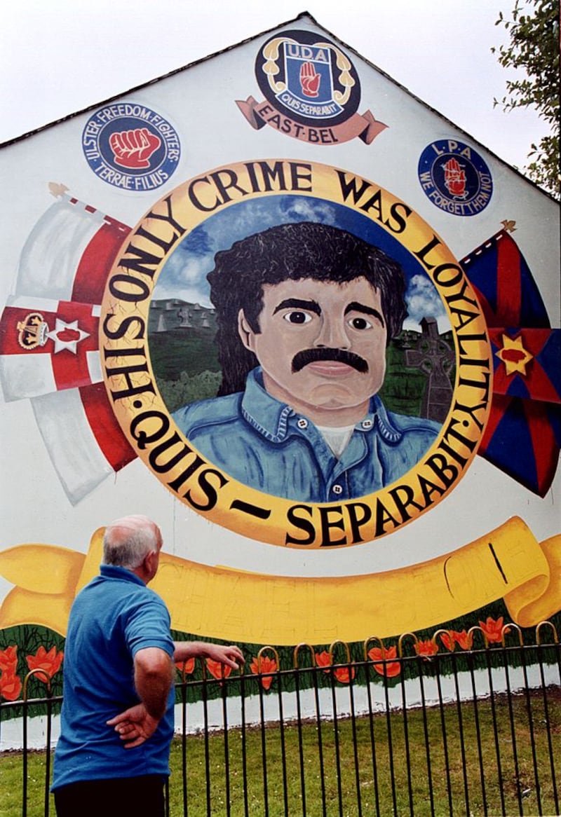 &nbsp;A man looks on at a painting of Michael Stone in East Belfast in 2013&nbsp;