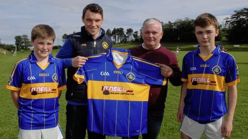 Mark O&#39;Neill &amp; Sons Building Contractors are to sponsor the Portaferry U14 hurlers. Mark is pictured presenting jerseys to his sons, Ryan and Calum, and U14 coach Darragh Mallon. These jerseys will be worn with pride at the national Feile in Kilkenny 