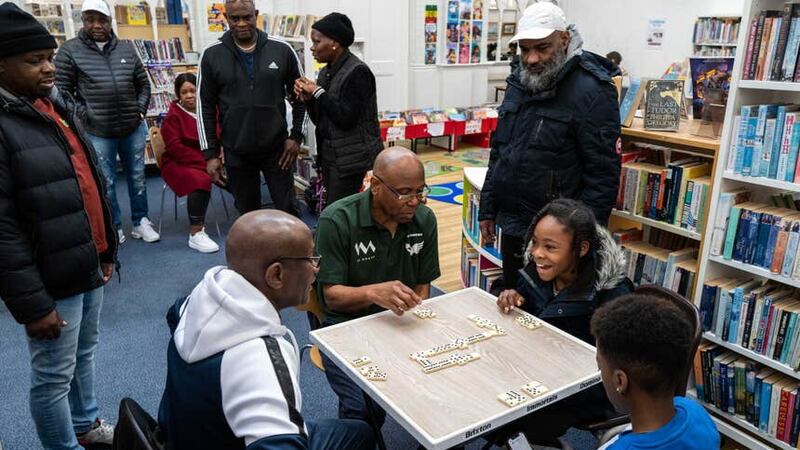 The Brixton Immortals Domino Club teaching the young generation how to play the game as part of a collaboration with Lambeth Libraries (Windrush: A Voyage through the Generations/Jim Grover/PA)