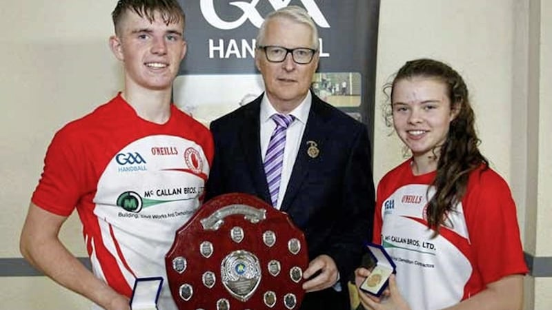 Antoin and Mair&eacute;ad Fox receive their All-Ireland 60x30 Championship medals from GAA Handball president Willie Roche. Both players have collected five major national titles each this year, an unprecedented achievement for two members of the same family