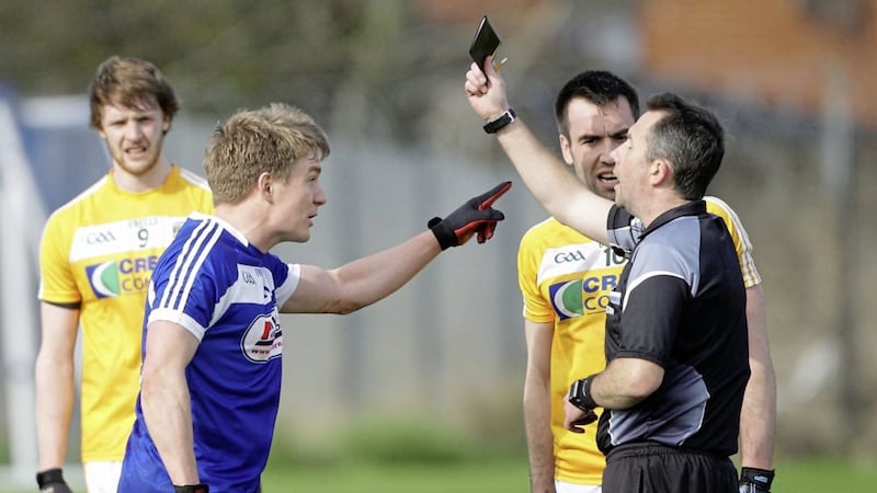 Laois&#39;s David Conway and Antrim&#39;s Kevin Niblock both argue about their simultaneous black cards from referee Eamon O&#39;Grady - but the official&#39;s task is extremely difficult. Picture by Cliff Donaldson 