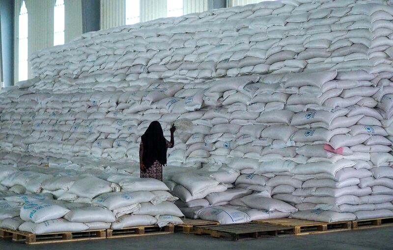A worker stands next to a pile of sacks of food earmarked for the Tigray and Afar regions in a warehouse of the World Food Programme in Semera Ethiopia (AP Photo, File)