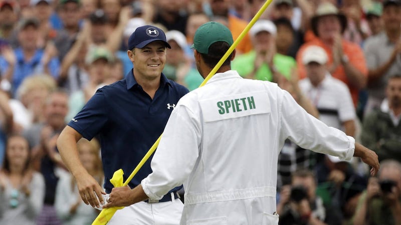 Jordan Spieth (left) celebrates with his caddie Michael Greller after winning the Masters golf tournament in April. He is now going for three Majors in a row at this weekend's Open Championship