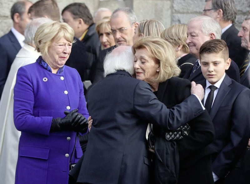President Michael D Higgins comforts Peter Sutherland&#39;s widow Maruja Sutherland. Pictures by Niall Carson, Press Association 