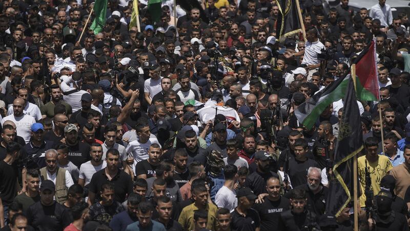 Mourners carry the body of three Palestinians during their funeral in the West Bank town of Jenin, Friday June 17 2022 (AP Photo/Nasser Nasser)&nbsp;