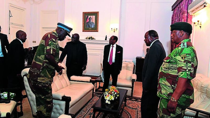&nbsp;Zimbabwean President Robert Mugabe, centre rear, meets with Defence Forces generals at State House, in Harare, Sunday PICTURE: Zimbabwe Herald via AP