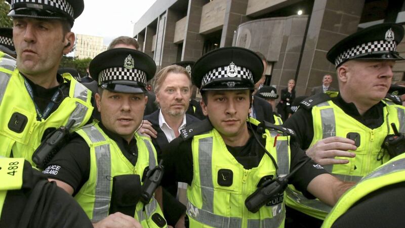 Former owner of Glasgow Rangers, Craig Whyte, centre, leaves Glasgow Sheriff Court after he appeared as part of a Police Scotland investigation into Rangers football club in 2015 