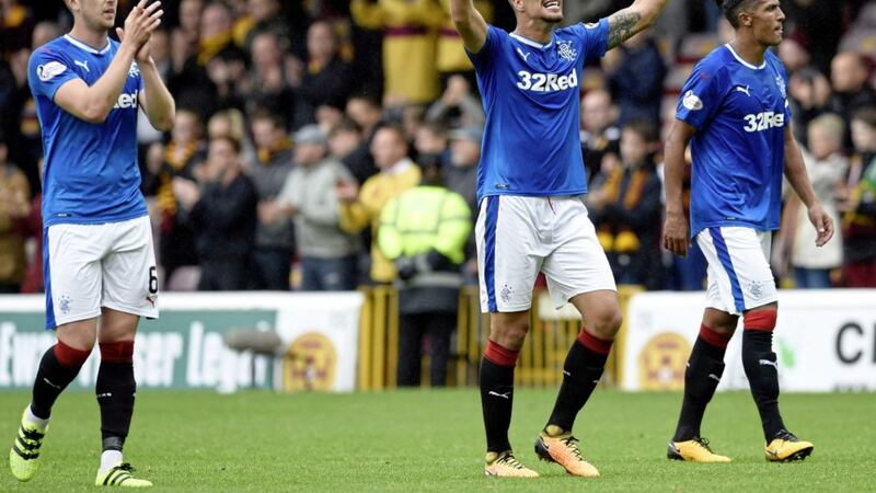 Rangers&#39; Fabio Cardoso (centre) celebrates in front of fans with team-mates Danny Wilson (left) and Bruno Alves after the Ladbrokes Scottish Premiership win at Fir Park, Motherwell 