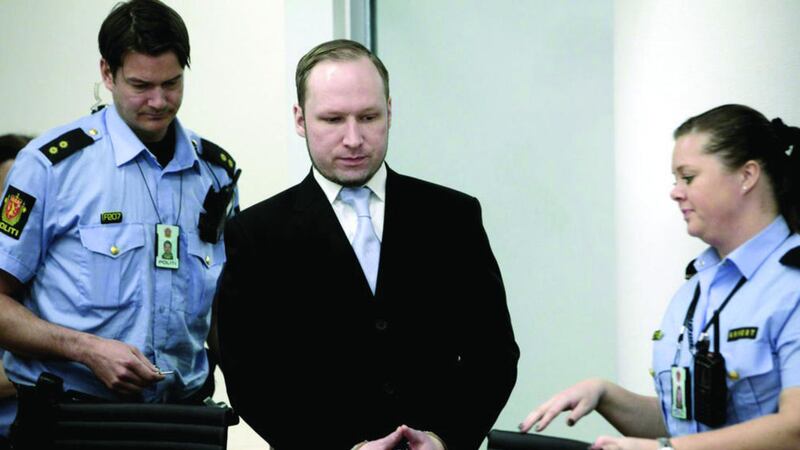 Anders Behring Breivik between two police officers in a courtroom in Oslo in 2012 after he was sentenced to 21 years for mass murder&nbsp;