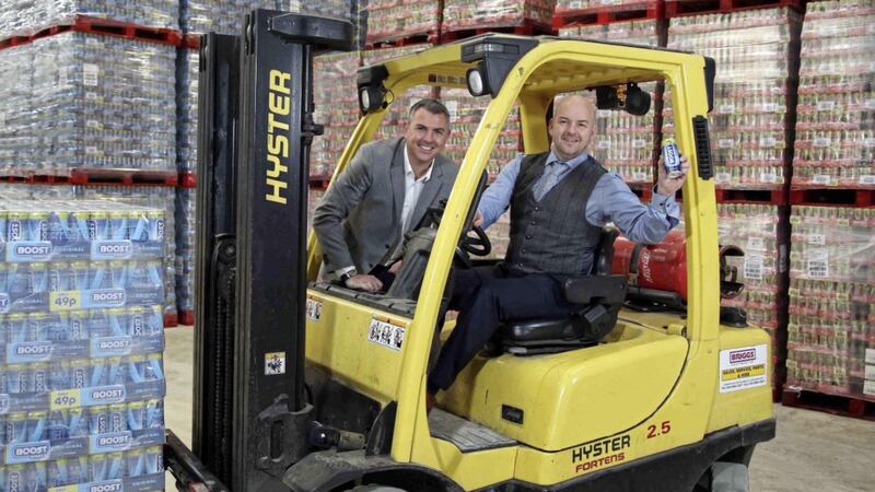 Boost Energy founder and managing director Simon Gray (left) celebrates a record year for the drinks company in Northern Ireland with Gareth Hardy, managing Director of Co Antrim-based Hardy Sales and Marketing 
