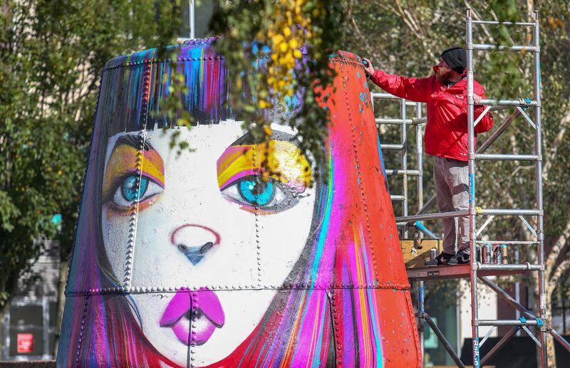 The giant floats in the centre of Cathedral Gardens, known locally as Buoy Park, beside St Anne's Cathedral get a splash of colour for the Hit the North festival on Culture Night 2018