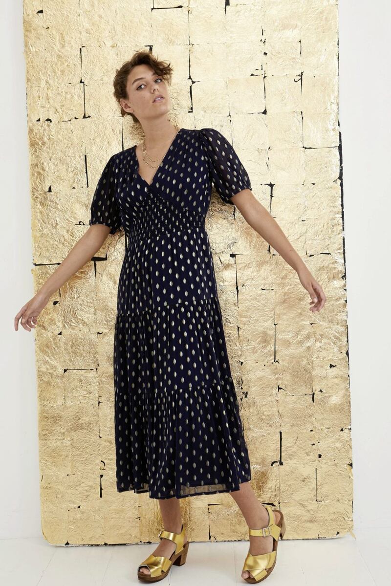 Oliver Bonas Sparkle Jacquard Spot Navy Blue Tiered Maxi Dress, &pound;89.50; Kitty Clogs Studio Mid Dansare Golden Leather Sandals, &pound;129, available from Oliver Bonas
