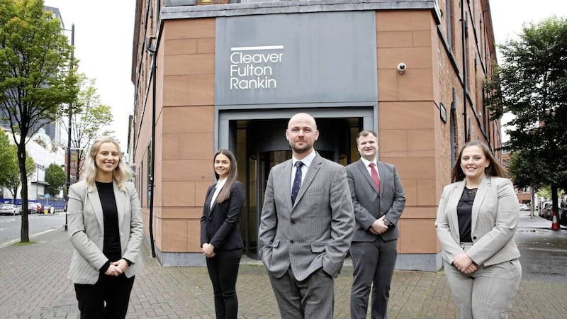 Aaron Moore (centre), training and development director at Cleaver Fulton Rankin, with new trainees (from left) Anna Friel, Adele Patterson, Edward Bergin and Cara Smart 