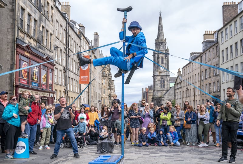 Street performer Malachi Frost entertains the crowds on the Royal Mile during Edinburgh Festival Fringe in 2023