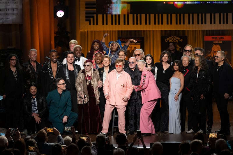 Sir Elton John, centre, and Bernie Taupin, centre right, were surrounded by artists who performed at the Gershwin Prize tribute concert (Kevin Wolf/AP)