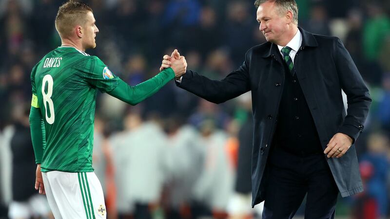 &nbsp;Northern Ireland's Steven Davis greets manager Michael O'Neill after the final whistle during the UEFA Euro 2020 Qualifying match at Windsor Park, Belfast.