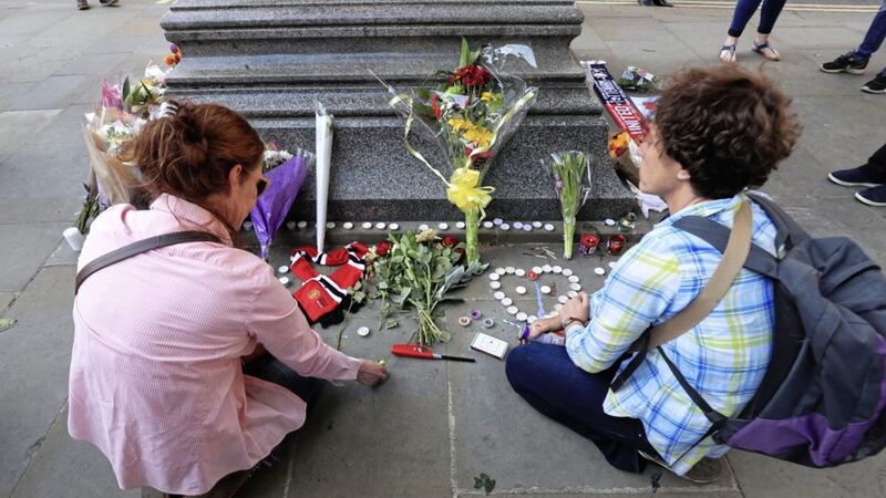 Tributes are left in Albert Square outside Manchester Town Hall. Picture by Danny Lawson/PA Wire 