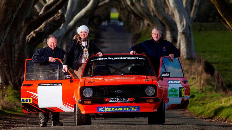 Causeway Coast and Glens Mayor, Cllr Michelle Knight-McQuillan (centre) and Circuit of Ireland Event Director Bobby Willis (left) were joined by Portrush co-driver Crawford Henderson (right) at the Dark Hedges to launch the Circuit in the Causeway Coast and Glens region. 