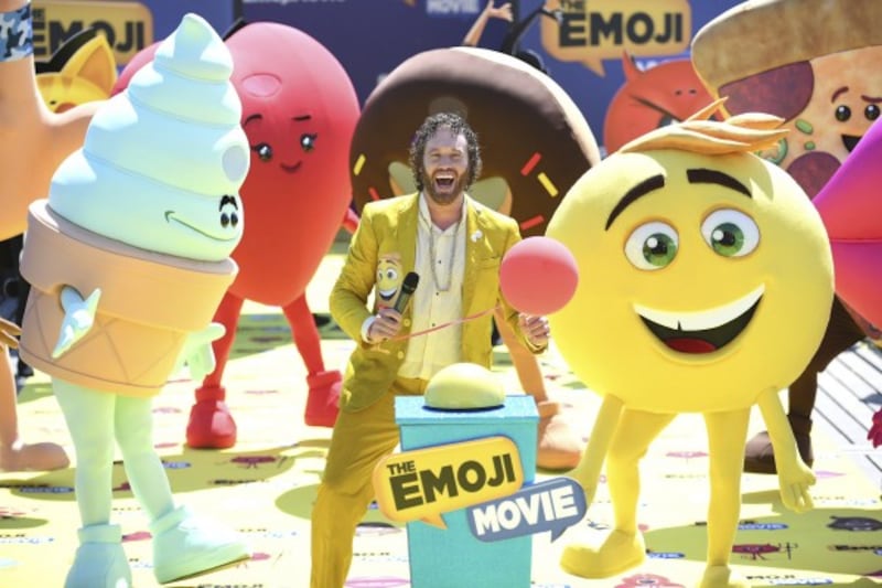 Actor T. J. Miller poses with characters during the photo call for the film The Emoji Movie, at the 70th international film festival