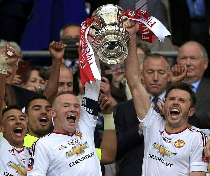 Manchester United's Wayne Rooney and Michael Carrick lift the FA Cup after last year's final victory at Wembley<br />Picture by PA