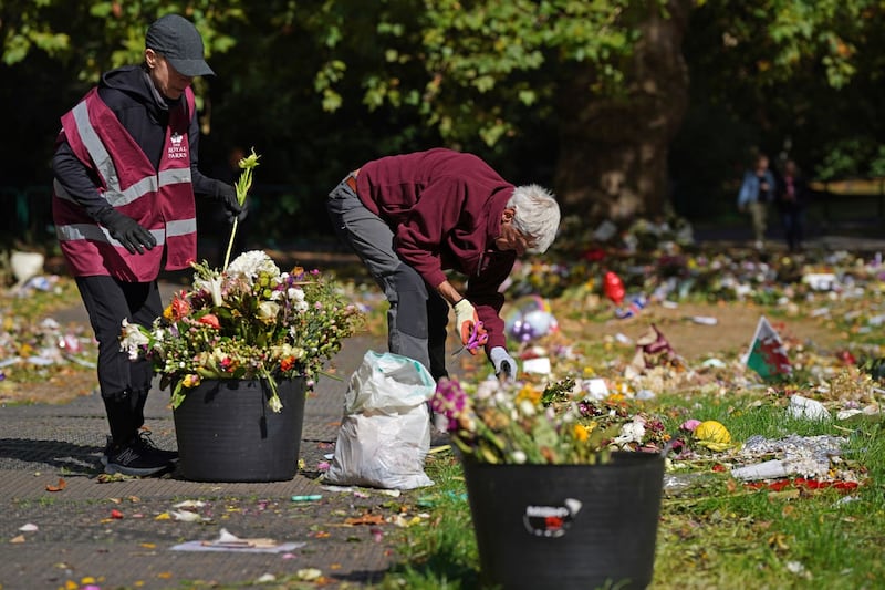 Royal Parks staff and volunteers start removing floral tributes from Green Park 