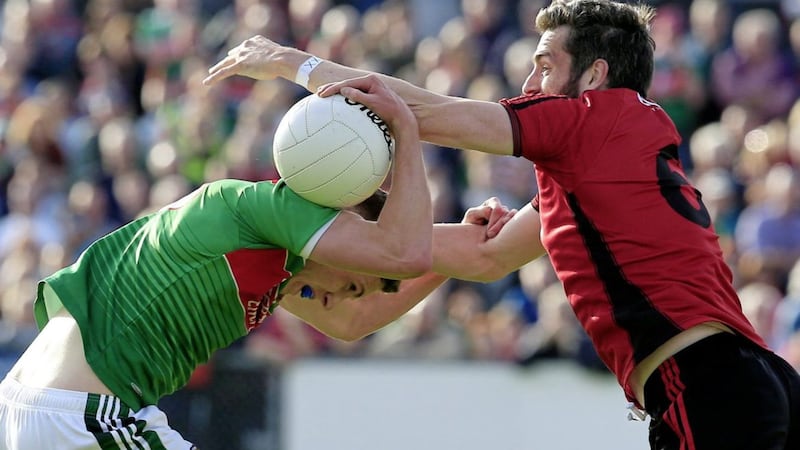 Down&rsquo;s Kevin McKernan battles for possession with Mayo&rsquo;s Fionn McDonagh at Pairc Esler on Saturday. Picture by Philip Walsh