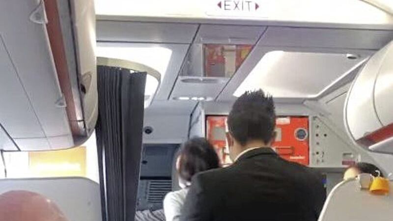 Footage showed the woman being escorted off the flight on Sunday 