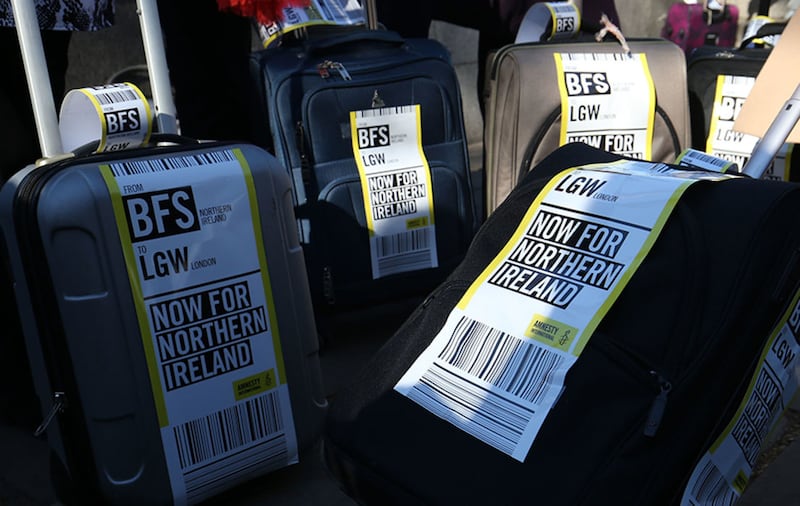 Luggage tags on suitcases, symbolising the women who travel from Northern Ireland to Great Britain for terminations, is pulled across Westminster Bridge by women impacted by Northern Ireland's strict abortion laws as they demand legislative change&nbsp;