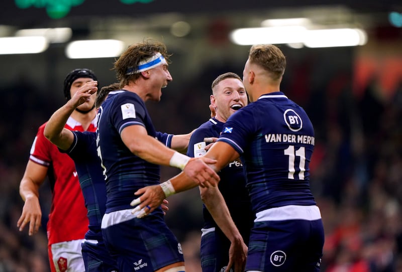 Duhan Van Der Merwe, right, celebrates with Finn Russell and Jamie Ritchie after scoring Scotland’s second try in their 27-26 victory over Wales