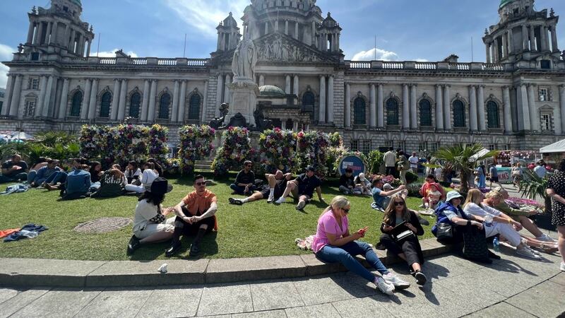 People enjoying the sunshine outside Belfast City Hall