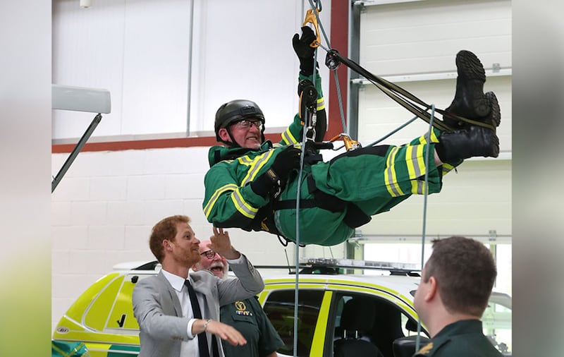 Prince Harry jokes with Ivan Kenny by spinning him around as he is using climbing equipment in a display, during his visit to Ballymena Northern Division HQ and Ambulance Station&nbsp;