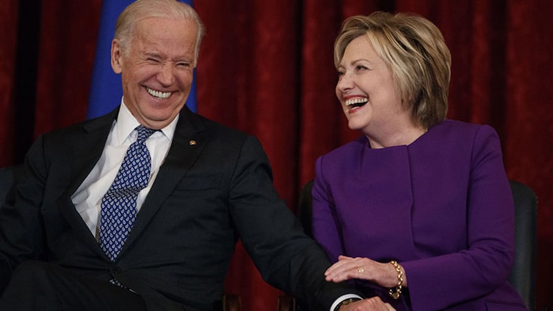 Vice President Joe Biden, left, laughs with former Secretary of State Hillary Clinton during a ceremony to unveil a portrait of Senate Minority Leader Harry Reid, D-Nev., on Capitol Hill, Thursday, Dec. <br />8, 2016, in Washington&nbsp;