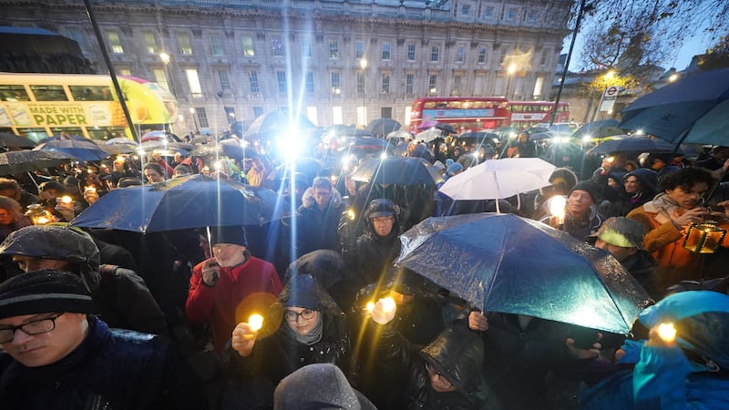People hold candles during an anti-hate vigil on Whitehall in central London (Yui Mok/PA)