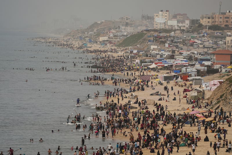 Palestinians on the beach during a heatwave in Deir al Balah, Gaza Strip (Abdel Kareem Hana/AP)