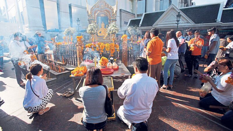 CENTREPIECE: Visitors pray at Phra Phrom, the Thai interpretation of the Hindu god Brahma, at the Erawan Shrine in Bangkok yesterday<br />PICTURE: Sakchai Lalit/AP&nbsp;