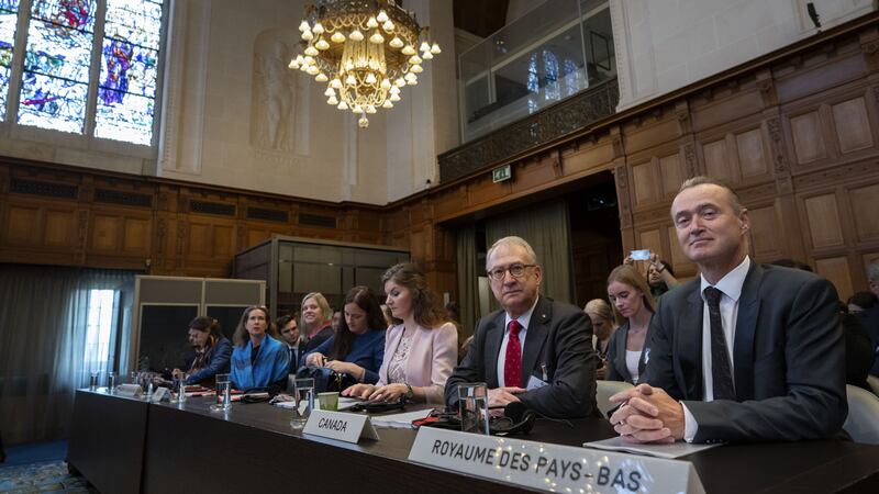 Members of the delegations for Canada and the Netherlands attend preliminary hearings at the International Court of Justice (AP Photo/Peter Dejong)