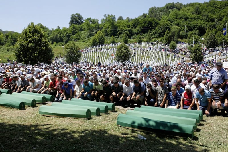 Bosnian Muslim people pray in front of coffins during a funeral ceremony this week for dozens of newly identified victims of the 1995 massacre