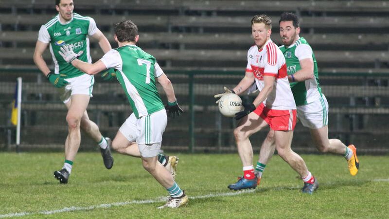 Derry&rsquo;s Enda Lynn holds the ball as Fermanagh trio Eoin Donnelly, Declan McCusker and Barry Mulrone close in during Saturday&rsquo;s Football League Division Three match at Brewster Park&nbsp;Picture by Jason Moncrieff