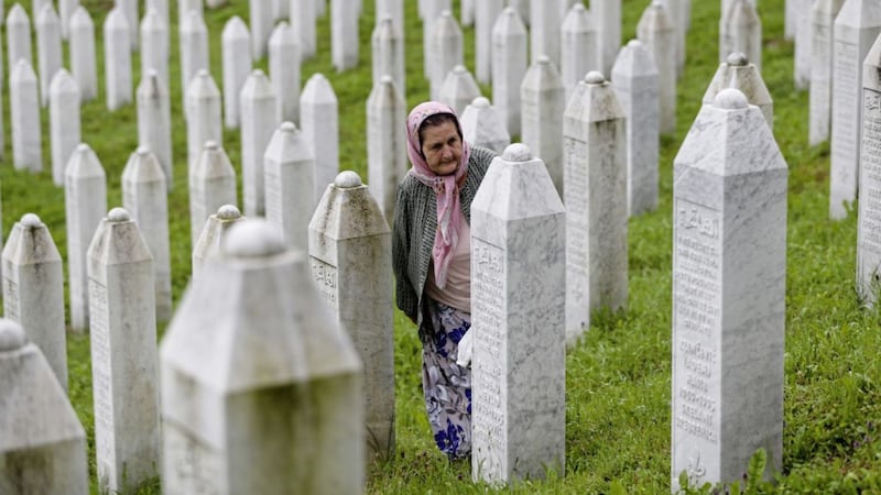 A Bosnian Muslim woman walks among graves at the memorial centre at Potocari near Srebrenica, where thousands gathered on Wednesday July 11, the 23rd anniversary of Europe&#39;s worst massacre since the Second World War, to hold prayers and attend the funeral for 35 recently identified victims. Picture by AP Photo/Amel Emric 