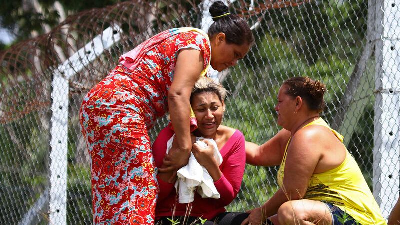 The wife of a prisoner who was killed in a riot cries outside Anisio Jobim Penitentiary Complex in Manaus, Brazil. Picture by Edmar Barros, Futura Press/Associated Press