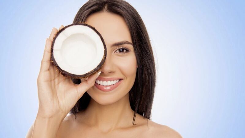 A Generic Photo of woman holding a coconut. See PA Feature TOPICAL Beauty Coconut. Picture credit should read: PA Photo/iStock. WARNING: This picture must only be used to accompany PA Feature TOPICAL Beauty Coconut.   