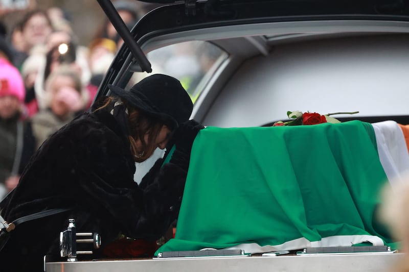 Victoria Mary Clarke, wife of Shane MacGowan, pays respects to his coffin as it arrives for the funeral. Picture by Niall Carson/PA Wire