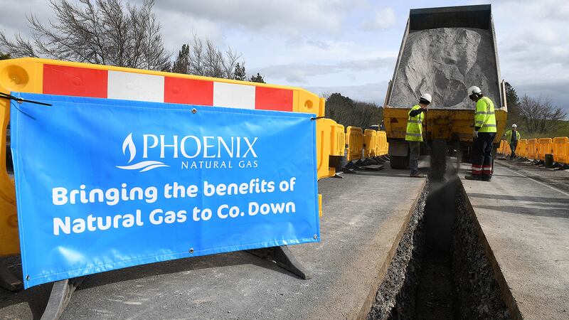 Image featuring a Phoenix sign and workers involved in installing new gas lines in Co Down.
